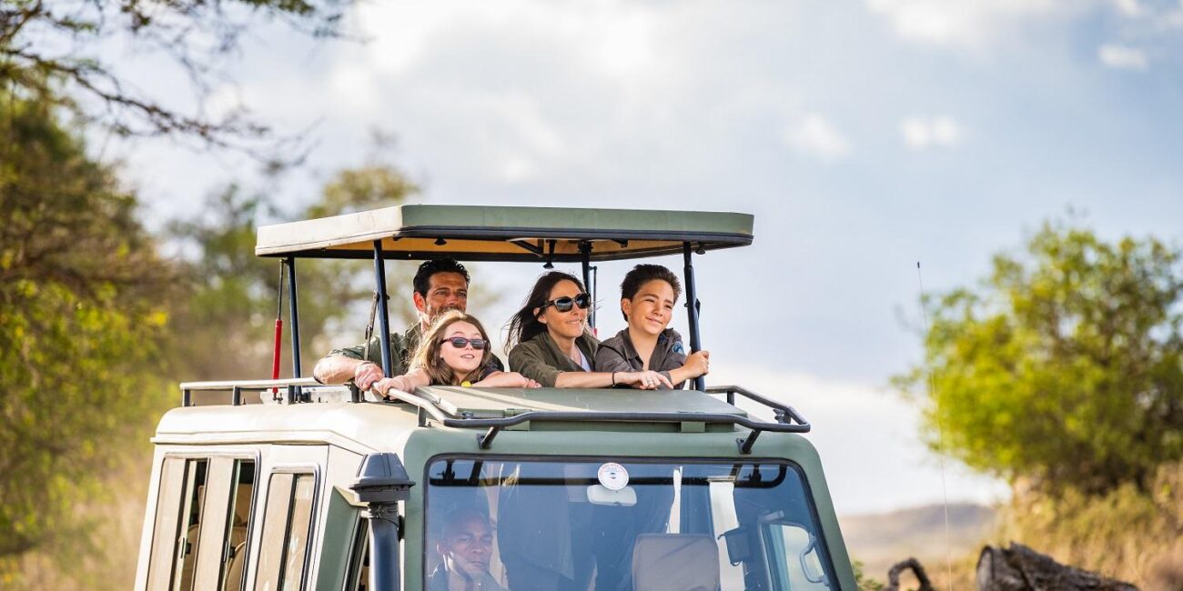 Family enjoying a kid-friendly Amboseli safari with elephants and Mount Kilimanjaro during a Kenya safari and beach holiday