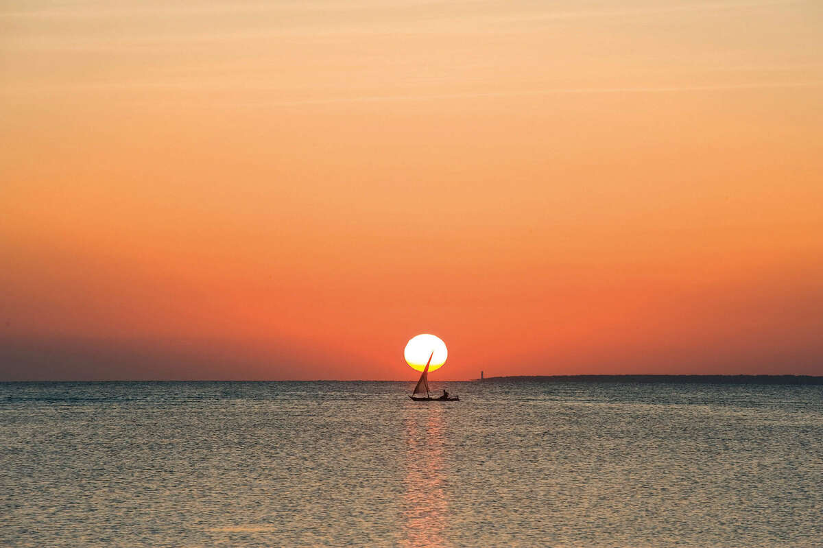 A boat sailing at Sunset in Zanzibar coast